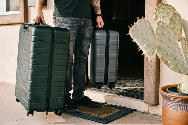 someone entering a condominium unit with luggage